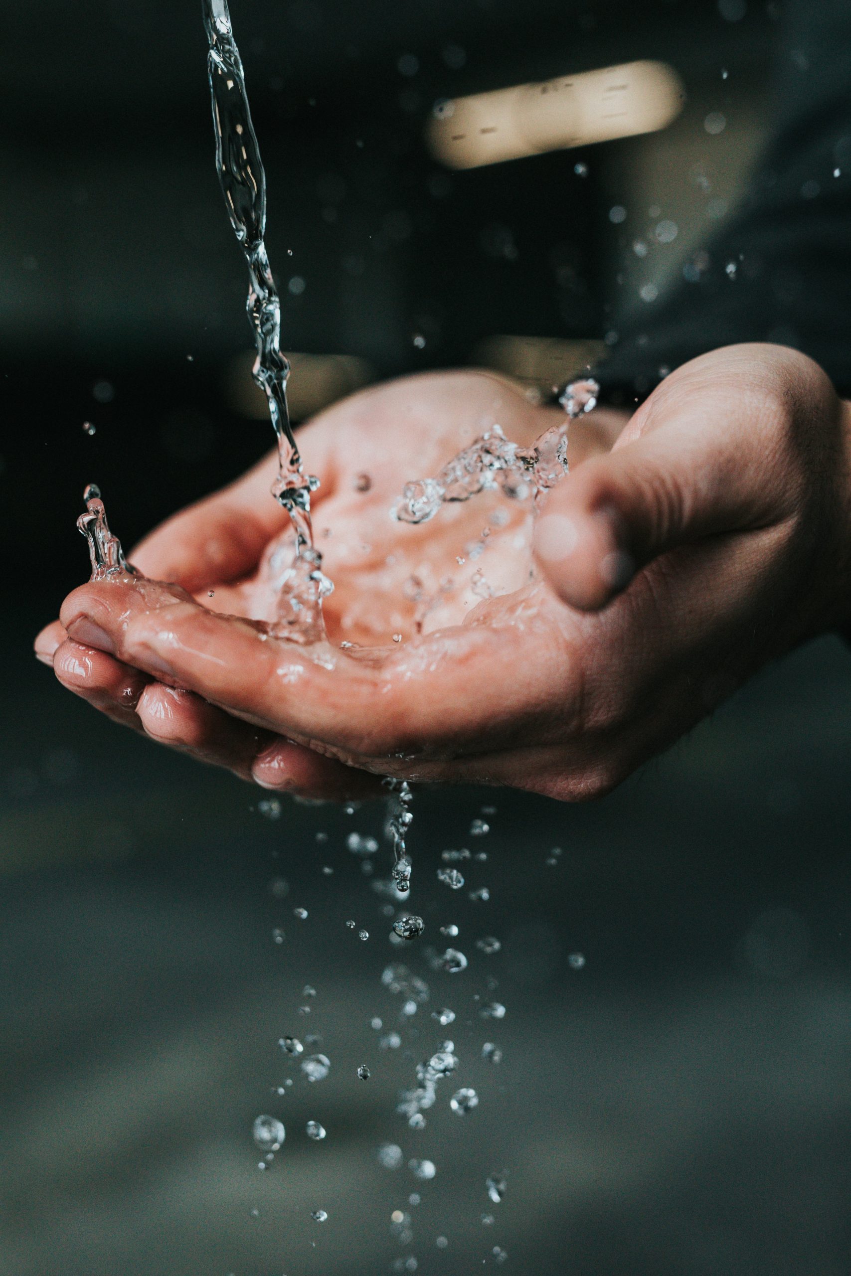 Clean water falling into cupped hands
